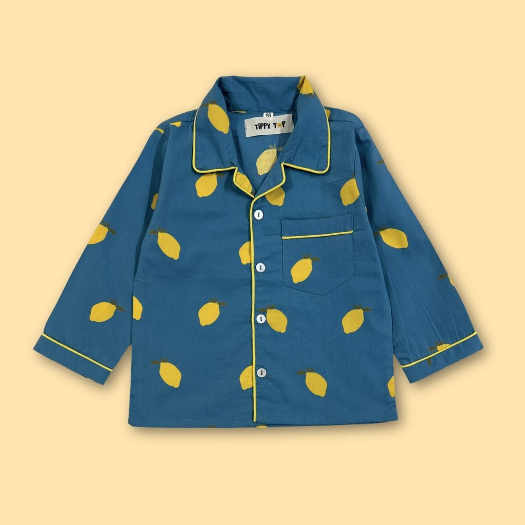 Blue pajama shirt with yellow lemon pattern on a beige background