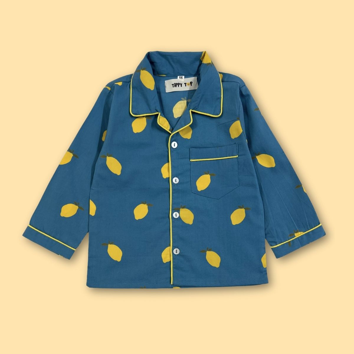 Blue pajama shirt with yellow lemon pattern on a beige background