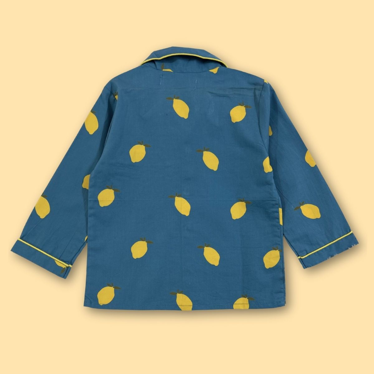 Blue jacket with yellow lemon pattern on a beige background