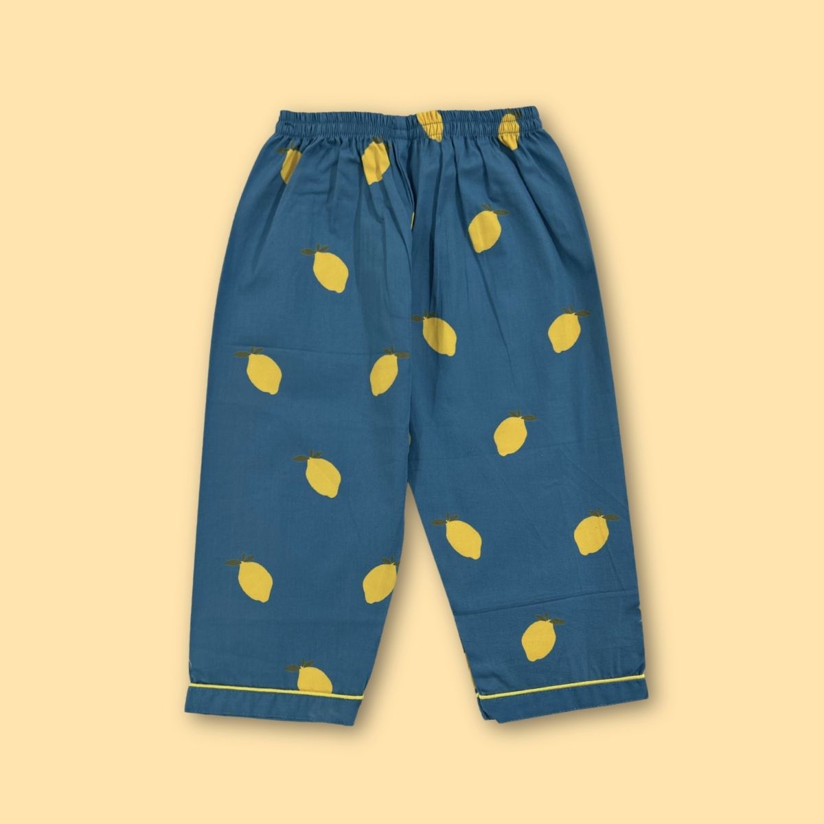 Blue pants with yellow lemon patterns on a beige background