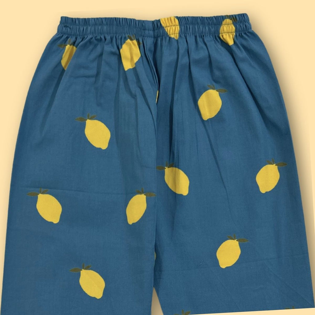 Blue pants with yellow lemon patterns on a beige background