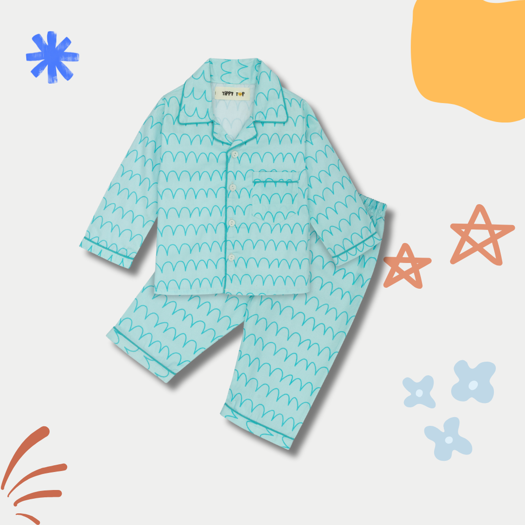 Children's blue pajama set with wave pattern on a light gray background