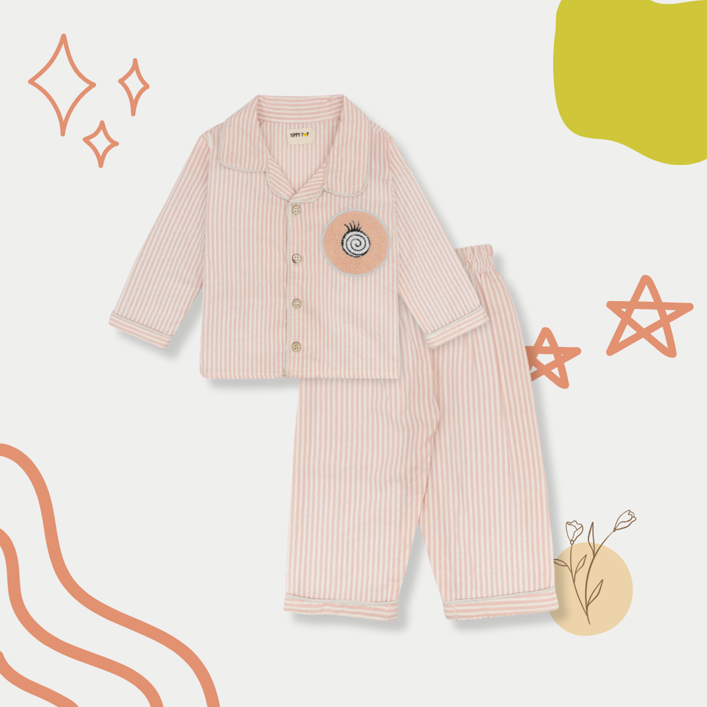 Pink striped pajama set with a circular patch on a white background with decorative elements.